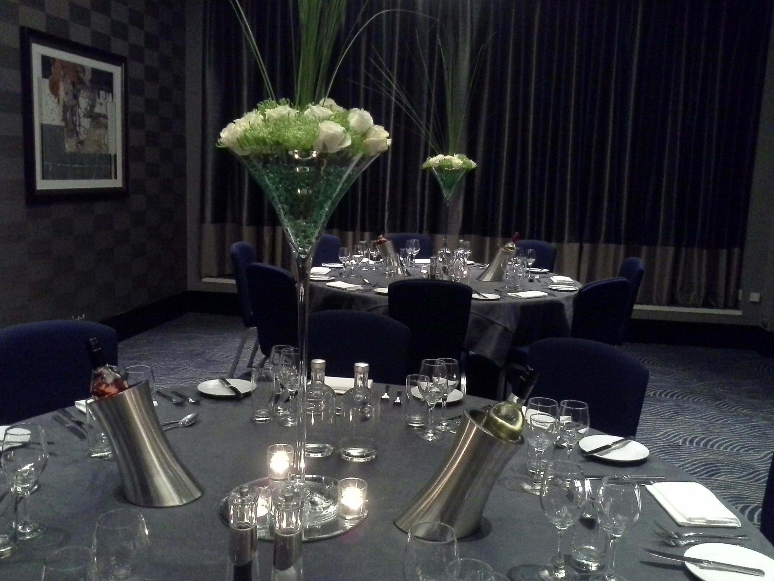 Elegant dining table with floral centerpieces for formal events at DoubleTree Victoria.